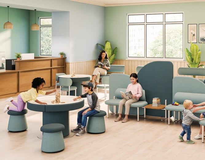 Coradle by MooreCo pediatric waiting room with children playing at a sensory table, Wobble Stools, and room divider seating in sage green and teal