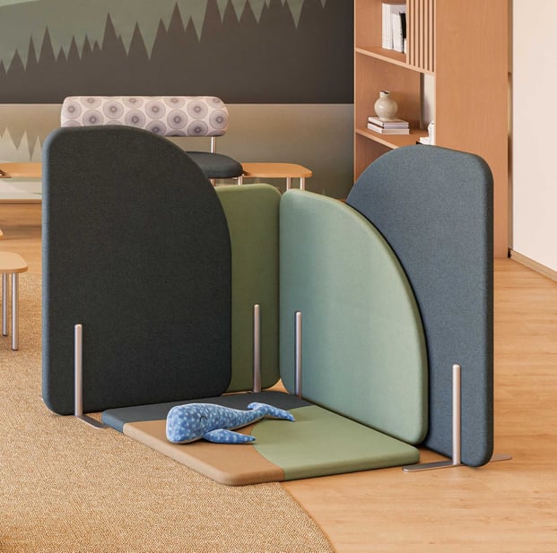 Coradle Room Dividers in charcoal, green, and blue with coordinating floor pads creating a child-oriented zone in a pediatric healthcare space
